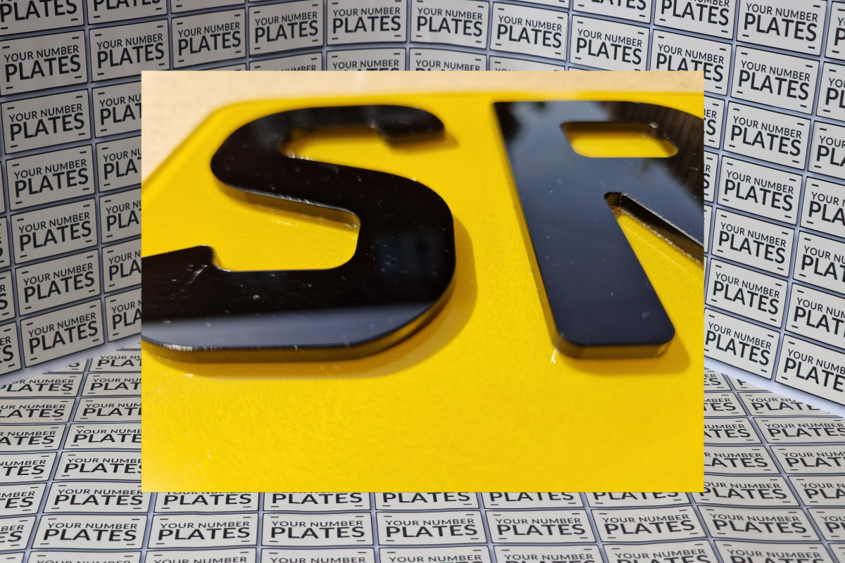 4d short number plate Digit close up on yellow reflective