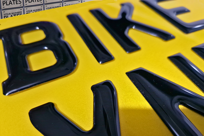 Close-up of raised gel characters on motorbike number plate 237×178 mm